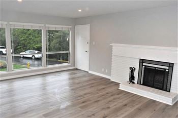 A living room with a fireplace and a large window